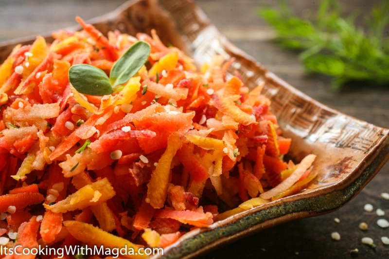 Grated carrots and apple salad on a square plate